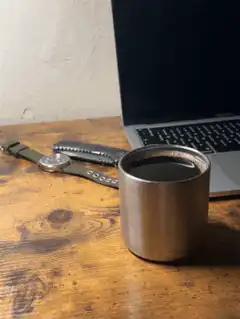 coffee cup on desk with laptop