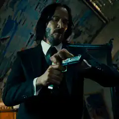 John Wick checks his gun