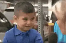 Shy boy covers face during interview