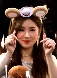 Woman in bear ears headband pointing fingers