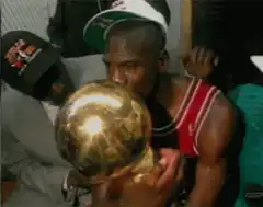 Michael Jordan kissing the championship trophy