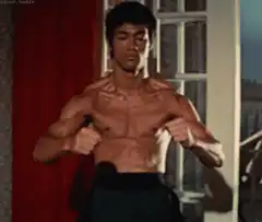 Bruce Lee flexing muscles