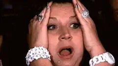 Woman holding head in shock