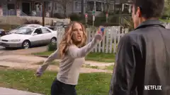 Woman throws blue object at man