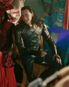 Loki smiling then looking serious