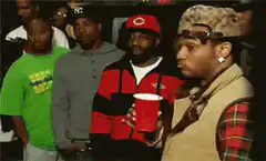 Usher holding a red cup and looking around