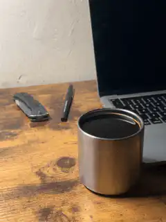 Coffee cup on desk with laptop