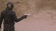 Man shooting gun with smoke