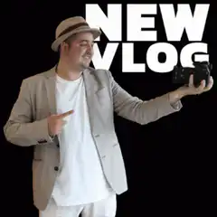 Man holding camera pointing to NEW VLOG text