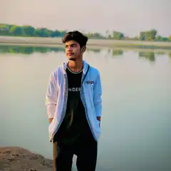 Young man standing by a lake