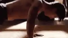 shirtless man doing pushups