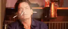 Charlie Sheen smoking two cigarettes