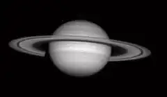 Grainy black and white image of Saturn