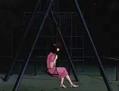 Woman in pink dress on swing at night