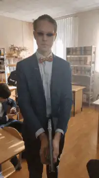 Guy with sunglasses and gun shows Rick Astley