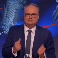 Man in suit gives thumbs up