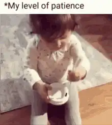 Baby drops cup and looks at camera