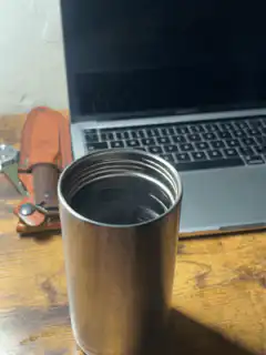 Steam rising from a metal cup