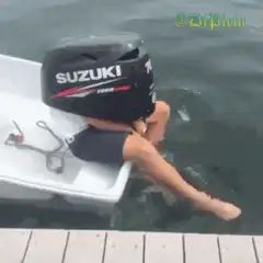 Person with Suzuki outboard motor on head