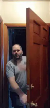 Man opens door and waves