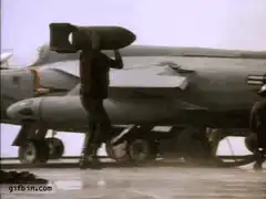 Airman carries bomb on shoulder