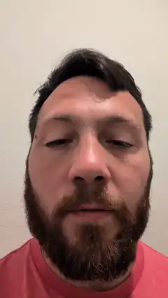 Man with beard blinking slowly