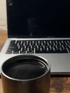 Coffee cup in front of laptop