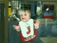 Baby pressed against glass window