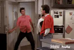 Kramer enters apartment in pink shirt