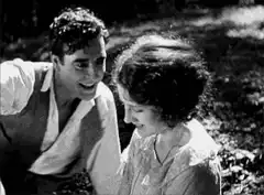Charlie Chaplin kissing a woman