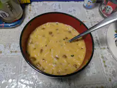 Bowl of savory rice porridge with spoon