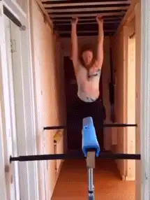 Woman does a kip on a gymnastics bar