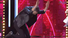 Man in leather jacket falls to knees on stage