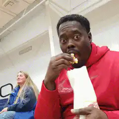 Man eating popcorn with wide eyes