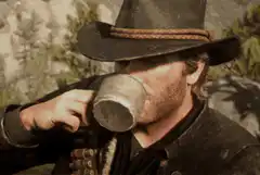 Arthur Morgan drinking from a tin cup