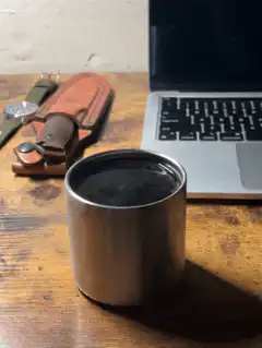 Steam rising from a metal cup
