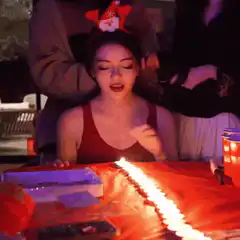 Woman blows out birthday candles