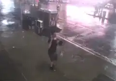 Man's umbrella flips inside out in wind