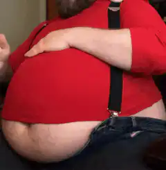 Man rubbing his large belly