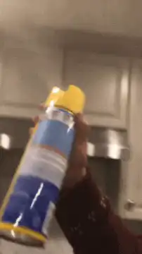hand shaking cooking spray can