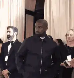 Kanye West smirking at an event