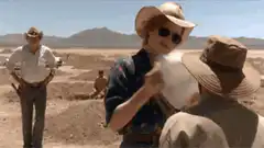 Woman in desert holding a sheep