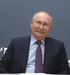 Vladimir Putin waving and smiling