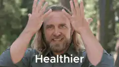 Man with hands up saying Healthier