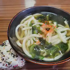 Bowl of udon soup with rice ball