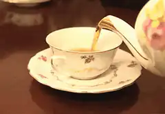 pouring tea into a cup