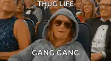 Woman in hoodie making gang signs