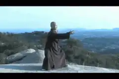 Buddhist monk doing tai chi on a mountain