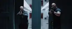 Vin Diesel aiming guns in a hallway