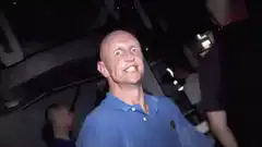Bald man dancing excitedly in a club